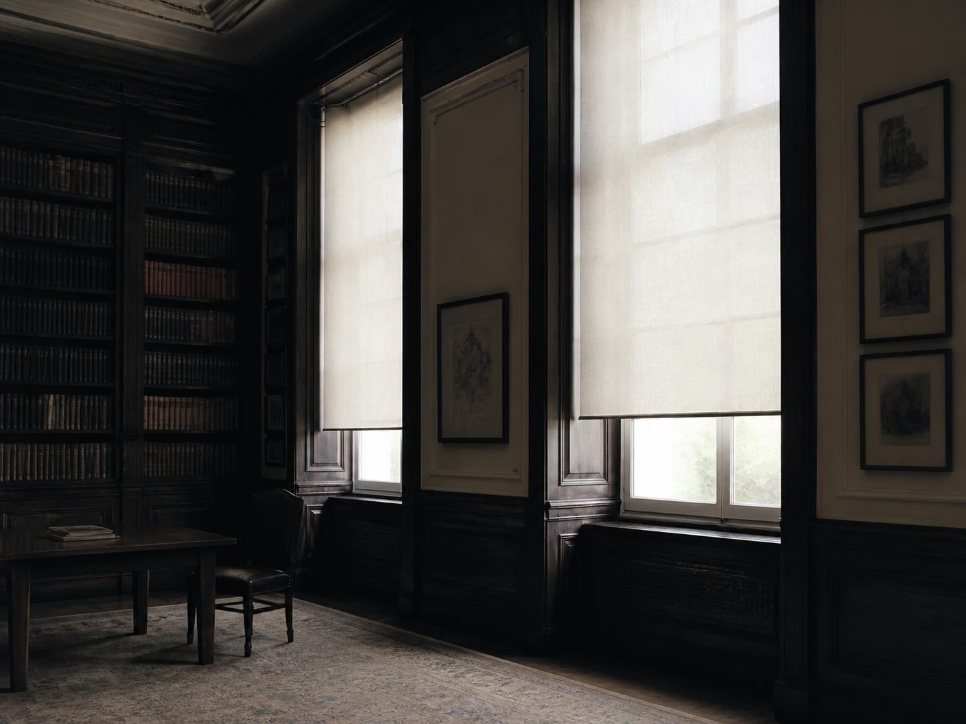 Quiet panelled reading room with tall shaded windows